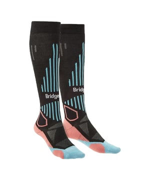 Women's Performance Lightweight Ski Socks: Embrace the ultimate fusion of technology and tailored comfort with our Women's Performance Lightweight Ski Socks. Fashioned to enrich your skiing escapades, these socks are imbued with a Performance Fit that meticulously contours to your feet. Whether you're navigating frosty trails or gliding on powdery slopes, expect a ceaseless bond between sock and skin that enhances every flex and turn. Expertly woven with the ambition to keep the contemporary skier's feet dry, comfy, and warm, our socks come equipped with an elite Moisture Management system and ThermoFit technology. The bliss of a Flat toe seam combined with intentional ShockZones affords your feet the comfort to ski from dawn until dusk. These performance-driven ski socks also feature a women-specific fit, providing that resilient support uniquely suited to the shape of a woman's foot. Topped with our signature Y-Heel design, they deliver a flawless fit that guards against slippage, ensuring your focus remains undisturbed on the thrilling alpine downhills. Experience the exceptional – these socks are your pledge for sanguine ski sessions. Key Product Specifications: - Tailored Women’s Fit - Advanced Moisture Management - Innovative ThermoFit Warmth - Smooth Flat toe seam - Protective ShockZones - Secure Y-Heel Design - Performance Fit for Stability - Lightweight, Breathable Fabric