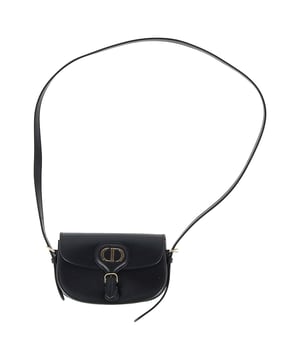 VINTAGE, RRP AS NEW
Timeless elegance in a compact design, the Dior New Dior Bobby Mini Bag in Black Calfskin Leather is a refined take on the classic hobo silhouette. Crafted from luxurious black box calfskin, this mini bag boasts the sophisticated lines and harmonious proportions that define Dior’s iconic style. The antique gold-finish metal details add a vintage charm, while the magnetic clasp with the decorative CD buckle exudes the House’s signature refinement. With a removable and adjustable leather shoulder strap featuring elegant pin buckles, the bag offers versatile styling options – carry it by hand, wear it over your shoulder, or style it crossbody for a laid-back, chic look. Inside, the calfskin and goatskin lining along with an interior slip pocket ensure both beauty and functionality. Whether you're dressing up for an evening out or adding a luxury touch to your day-to-day look, the Dior Bobby Mini Bag is the ultimate accessory for every occasion.



with Box, Dust bag

Dior New Dior Bobby Mini Bag in Black Calfskin Leather
vCondition: Excellent
Signs of wear: No retail tag, No visible sign of wear., 
Packaging: Box, Dust bag
Color: black
Material: Leather | leather
Size: One Size | One Size
Measurements: Width: 170; Height: 100; Length: 170; Handle drop: 0; Strap length: 580
SKU: NAPPUGBBA458696W