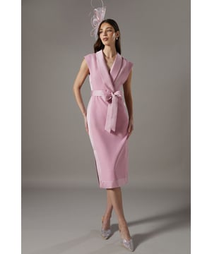 Sophisticated tuxedo-inspired dress with satin lapels
        Elegant wrap-style front with a flattering tie waist
        Sleek midi length for a refined silhouette
        Structured shoulders for a polished look
        Versatile crepe fabric with a subtle stretch for comfort
    
    Make a striking entrance at your next formal event with this exquisite tuxedo-inspired dress from Coast. The sleek midi length and wrap-style front create a figure-flattering silhouette, while the satin lapels add a touch of luxury. Perfect for weddings, races, or any sophisticated occasion, this dress can be styled with statement earrings and a fascinator for a truly head-turning ensemble. Pair with strappy heels and a clutch bag to complete your look. The versatile design allows for easy transition from day to evening events, making it a valuable addition to your occasion wear wardrobe. With its blend of classic tailoring and contemporary flair, this dress is sure to become a favourite for those who appreciate timeless elegance with a modern twist.