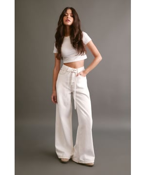 Wide leg silhouette for a relaxed, on-trend look
        High-rise waist with belt loops for a flattering fit
        Removable fabric belt for versatile styling options
        Classic five-pocket design for practicality
        Ankle-grazing length perfect for showcasing footwear
    
    Make a bold statement with these eye-catching wide leg jeans from NastyGal. The relaxed silhouette offers both comfort and style, whilst the high-rise waist cinches you in at your smallest point. The removable fabric belt allows for customisable styling - wear it looped through for a defined waist or remove it for a more laid-back vibe. These versatile trousers transition effortlessly from day to night. For a casual daytime look, pair with a cropped tank top and trainers. When the sun sets, swap your flats for chunky platform boots and add a biker jacket for an edgy evening ensemble. Perfect for family gatherings, brunch dates, or casual Fridays at the office, these jeans will quickly become your go-to for effortless style.