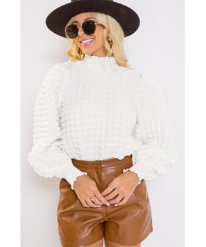 Textured blouse with smocked mock neck and puff sleeves
  Unique fabric adds texture and interest
  Versatile piece for both casual and dressy occasions
  Available in various sizes (see size chart for measurements)
Material: 95% Polyester 5% Elastane