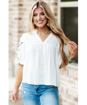 White floral embroidered blouse with puff sleeves
  Lattice design and notched neck
  Relaxed fit for comfortable wear
  Colorful floral embroidery on sleeves
  Suitable for most casual occasions
  Available in different sizes
Material: 100% Polyester