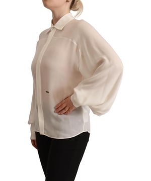 Marca: DSQUARED2  
Color: Blanco Roto  
Material: 100% Seda  
Mangas largas  
Blusa con cuello  
Cierre de botones  
Detalles sutiles del logo