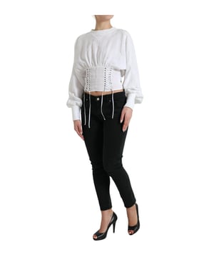 Top corto auténtico de Dolce & Gabbana  
  Mangas largas  
  Estilo corsé  
  Color: Blanco  
  Material: 100% Algodón  
  Cierre tipo lazo  
  Detalles con el logo característico  
  Hecho en Italia  
  Tallas para mujeres  