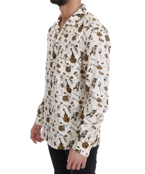 Authentisches Dolce & Gabbana Seiden-Jazzhemd  
Material: 100 % Seide  
Farbe: Weiß mit goldfarbenem und schwarzem JAZZ-Motivdruck  
Lässiger Stil mit einer Brusttasche  
Vollständige Knopfleiste vorne  
Luxuriöses Gefühl und Logodetails  
Hergestellt in Italien