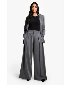 Wide-leg design for a dramatic silhouette
        High-waisted fit with pleated front detail
        Smooth, flowing fabric for effortless movement
        Versatile length suitable for various shoe choices
        Tailored waistband for a flattering fit
    
    Make a bold statement with these striking wide-leg trousers from Boohoo. Perfect for the fashion-forward woman who wants to stay on-trend while maintaining comfort, these trousers offer a blend of style and versatility. The high-waisted design with pleated front detail creates a sleek silhouette, while the flowing fabric ensures ease of movement throughout the day. Pair them with a fitted black top and blazer for a chic office look, or dress them down with a casual tee and trainers for weekend brunches. The adaptable length allows for various styling options, from flats to heels, making these trousers a go-to choice for multiple occasions. Whether you're attending a family gathering or heading out for a casual dinner with friends, these wide-leg trousers will keep you looking effortlessly stylish and feeling confident.