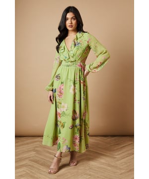 Enchanting floral print midi dress
        Flattering V-neckline with ruffle detail
        Long sleeves with elegant cuffs
        Cinched waist with matching fabric belt
        Stylish cut-out detail at the back
    
    Embrace the essence of feminine charm with this captivating printed midi dress from Oasis. The flowing chiffon fabric creates a graceful silhouette, while the vibrant floral pattern adds a touch of whimsy to your ensemble. Perfect for daytime events, this versatile piece can be styled for various casual occasions. Pair it with strappy sandals and a woven bag for a relaxed garden party look, or dress it down with white trainers and a denim jacket for a leisurely weekend brunch. The cut-out detail at the back adds a subtle hint of allure, making this dress a standout choice for family gatherings or afternoon tea with friends. Accessorise with delicate gold jewellery to complement the dress's romantic appeal and create a look that's both effortless and sophisticated.