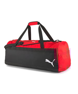 The Puma 81L TeamGoal 23 Black/Red Large Team Bag is the ultimate choice for athletes or teams in need of a spacious, durable, and high-quality bag to transport gear. With an impressive 81-liter capacity, this bag is designed to hold all your essential equipment, from clothing and shoes to balls and accessories. Its rugged construction ensures long-lasting durability, while the bold black and red design offers a sleek, professional look.
Key Features:
Massive 81L Capacity: 

The 81-liter capacity offers ample space for all your team or personal gear, making it ideal for large sports teams, training sessions, or tournaments. Thereâ€™s plenty of room for uniforms, boots, training equipment, and more.


Durable Design: 

Made with high-quality, durable materials, this bag is built to withstand heavy use, making it perfect for frequent travel and handling.


Multiple Pockets: 

The bag includes side compartments and a front pocket, allowing you to organize your smaller items like keys, phones, or accessories for easy access.


Easy to Carry: 

Equipped with adjustable shoulder straps and a padded carry handle, the bag offers multiple carrying options for comfort, whether you're carrying it over your shoulder or by hand.


Ventilated Sections: 

Includes ventilated sections to keep your gear fresh, reducing moisture buildup, especially after intense workouts or matches.


Bold Black/Red Colorway: 

The black and red color combination provides a sleek, sporty look that reflects Puma's signature style, perfect for any team or individual athlete.


Puma Branding: 

Featuring the Puma logo on the front, this bag represents the brand's commitment to quality and performance, trusted by athletes worldwide.


The Puma 81L TeamGoal 23 Black/Red Large Team Bag is a must-have for athletes or teams looking for a reliable, spacious bag that offers ample storage, organization, and durability. Whether you're traveling to a match, heading to training, or simply need a large, high-quality bag for your gear, this bag has you covered.