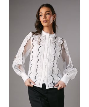 Exquisite lace organza blouse with scalloped detailing
        Elegant collared neckline for a refined look
        Sheer long sleeves with delicate lace pattern
        Button-down front for versatile styling options
        Semi-sheer design with strategically placed lace panels
    
    Embrace sophistication with this stunning lace organza blouse from Coast. Perfect for those special occasions that demand an air of elegance, this blouse combines intricate lace detailing with a classic silhouette. The scalloped edges and sheer sleeves add a touch of romance, while the collared neckline keeps the look polished and refined. Style it with tailored trousers and stilettos for a chic ensemble at weddings or race days. For a more contemporary twist, pair it with high-waisted wide-leg trousers and statement earrings. The versatility of this blouse allows for effortless transitions from day to evening events, making it a valuable addition to your occasion wear wardrobe. Its timeless design ensures you'll turn heads at any sophisticated gathering, from formal dinners to gallery openings.