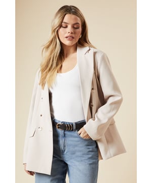 Oversized fit for a relaxed and comfortable silhouette
        Double-breasted design with stylish button detailing
        Notched lapel collar adds a classic touch
        Long sleeves with subtle shoulder padding for structure
        Versatile woven fabric suitable for various occasions
    
    Embrace effortless sophistication with this oversized double-breasted blazer from Dorothy Perkins. Perfect for the fashion-forward woman in her 30s who appreciates a blend of trend and comfort. The relaxed fit allows for easy layering over your favourite tops, while the classic double-breasted front presents a polished look. Style it with wide-leg jeans and trainers for a chic brunch ensemble, or throw it over a midi dress for a baby shower. The versatile nature of this blazer makes it an ideal choice for family gatherings and casual outings. Its neutral tone ensures it pairs well with various colours in your wardrobe. For a trendy twist, roll up the sleeves and add some statement jewellery. This blazer is your go-to piece for elevating everyday looks with minimal effort.