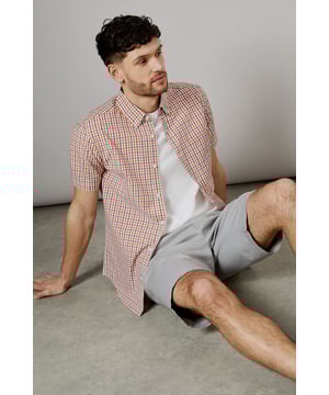 Vibrant check pattern for a stylish summer look
        Short sleeves for optimal comfort in warm weather
        Button-down collar for a smart-casual appearance
        Chest pocket adds a functional touch
        Versatile woven fabric suitable for various occasions
    
    Embrace the essence of laid-back sophistication with this eye-catching Helios check shirt from Maine. The striking pattern adds a dash of personality to your wardrobe, making it an ideal choice for casual outings and relaxed social gatherings. Style it effortlessly with light-coloured chino shorts and white trainers for a fresh summer ensemble. For a more polished look, pair it with tailored trousers and loafers. The short sleeves and breathable cotton fabric ensure you stay cool and comfortable, whether you're enjoying a family barbecue or meeting friends for a leisurely brunch. This versatile shirt transitions seamlessly from day to night, making it a must-have addition to your casual wardrobe. Layer it over a plain white t-shirt for added dimension, or wear it unbuttoned over a vest for a relaxed beach-ready look.