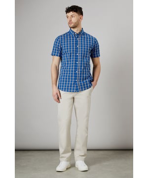 Vibrant check pattern for a bold, eye-catching look
        Short sleeves perfect for warmer weather
        Button-down collar for a smart-casual appearance
        Chest pocket adds a functional touch
        Regular fit allows for comfortable movement
    
    This Maine short sleeve shirt radiates casual charm with its striking check pattern. The bright blue hues create a lively aesthetic that's sure to turn heads. Crafted from pure cotton, it offers breathability and comfort ideal for summer days. Style it with light-coloured chinos and white trainers for a fresh daytime look perfect for weekend brunches or casual gatherings. For a more relaxed vibe, pair it with your favourite denim shorts and sandals for a seaside stroll. The versatile design allows for easy transition from day to night - simply swap your trainers for loafers and you're ready for an evening at the local pub. This shirt is a wardrobe essential that combines style and practicality, making it a go-to choice for various casual occasions throughout the warmer months.