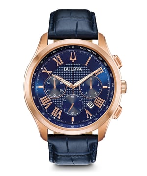 This Bulova Wilton Chronograph Watch for Men is the perfect timepiece to wear or to gift. It's Rose Gold 46 mm Round case combined with the comfortable Blue Leather watch band will ensure you enjoy this stunning timepiece without any compromise. Operated by a high quality Quartz movement and water resistant to 3 bars, your watch will keep ticking. This classic chronograph watch gives a comfortable feeling with its croco-embossed blue leather strap, it's perfect for every occasion -The watch has a calendar function: Date, Stopwatch, Tachymeter, Luminous Hand High quality 22 cm length, 22 mm wide Blue Leather strap with a Deployment clasp Case diameter: 46 mm, Case height: 13 mm and Case color: Ip-rosé Dial color: Brown