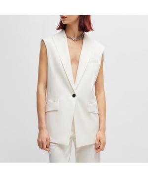 modieus oversized mouwloos vest - eenknoopssluiting - paspelzak op de borst - langere lengte