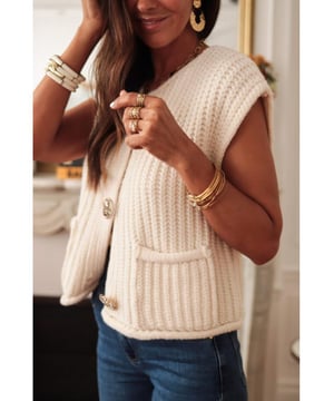 White solid textured knit sweater vest
  Buttoned front closure for a classic look
  Sleeveless design for easy layering
  Side pockets for practical functionality
Material: 100% Acrylic