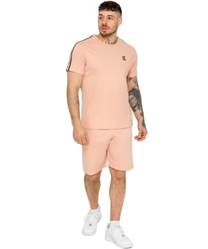Upgrade your casual look with the Kruze Men's Tape Tracksuit, combining comfort and style. The T-shirt features a ribbed crew neck and tape detailing on the sleeves for a sporty touch, with a Kruze rubber print on the chest for signature style. The fleece shorts have a regular fit, elasticated waistband with a drawstring, and tape design on the sides. A Kruze rubber print on the left thigh adds a bold finish, while the soft fleece lining ensures comfort.