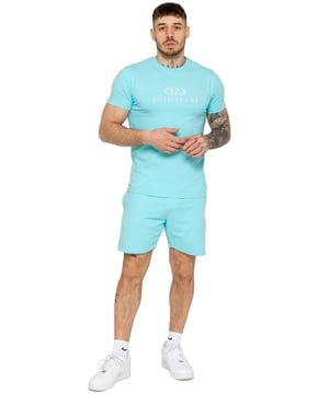The Enzo Men's Gym Tracksuit is designed for both performance and style. The slim-fit T-shirt contours to the body for a sleek, athletic look, while the ribbed crew neck adds durability. The stretch material with Lycra fabric ensures maximum flexibility and comfort. The matching gym shorts feature a regular fit for ease of movement, with an elasticated waistband for a secure fit. The bold Enzo Jeans branding on both pieces adds a sporty edge.