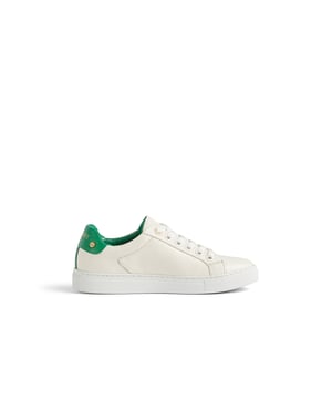 A tennis-style shoe that's perfect for the spring season, our new Sigture trainers are so classic, you'll love them forever. Crafted from super-soft and comfortable white ppa leather, they have white laces tipped in gold metal with a matching gold bar to the front, a green leather back counter with the LKB logo and gold disc detail, and a white rubber sole. Wear them with your favourite spring dresses, jeans and even shorts, when the time comes.