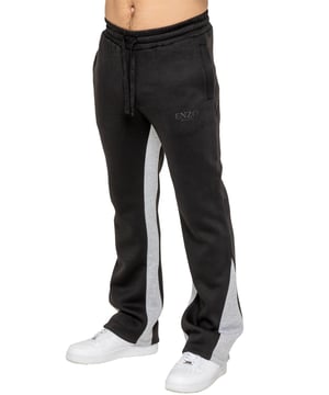 The Enzo Milano Men's Flared Joggers offer a perfect blend of comfort and style with a relaxed fit. Designed with an elasticated waistband and adjustable drawstring, they provide a customizable fit for maximum comfort. The joggers feature a contrast inner panel for a unique, stylish touch. With two side pockets for convenience and a sleek Enzo Milano rubber print on the leg, these joggers make a bold statement while staying practical.