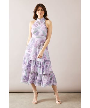 Elegant halterneck design for a sophisticated look
        Tiered midaxi length offering graceful movement
        Alluring floral print throughout the dress
        Sleeveless style perfect for warm-weather events
        Flattering fitted bodice transitioning into a flowing skirt
    
    This stunning halterneck tiered midaxi dress from Wallis is the epitome of refined elegance. The dress features a captivating floral print that adds a touch of romance to your ensemble. Its tiered design creates beautiful movement as you walk, while the fitted bodice accentuates your silhouette before flowing into a graceful skirt. Perfect for formal occasions, this dress will make you feel confident and glamorous at weddings, races, or graduations. Style it with strappy heels and a clutch bag for a polished look. For cooler evenings, drape a lightweight shawl over your shoulders. The versatile design allows for easy transition from day to night events, ensuring you remain the picture of sophistication throughout any occasion.