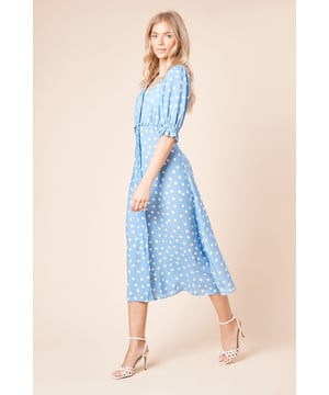 Charming polka dot pattern throughout
        Elegant midi length for versatile styling
        Flattering scoop neckline
        Feminine puff sleeves with elasticated cuffs
        Button-front detail for easy wear
    
    Embrace effortless charm with this delightful polka dot midi dress from Dorothy Perkins. The scoop neckline and puff sleeves create a feminine silhouette, while the button-front detail adds a touch of vintage appeal. Perfect for casual outings, this dress can be styled with flat sandals and a woven bag for a relaxed brunch with friends. For family gatherings, pair it with wedge espadrilles and delicate jewellery. The midi length offers versatility, making it suitable for various occasions. Layer with a lightweight cardigan for cooler days or dress it up with strappy heels for an evening out. This dress is a wardrobe essential that combines comfort and style, ideal for the woman who appreciates a trend-conscious yet modest look.