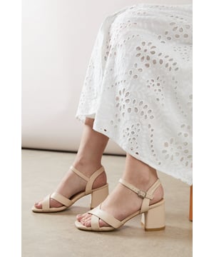 Chic cross-strap design for a sophisticated look
        Comfortable low block heel, between 5 and 6.5cm in height
        Wide fit for enhanced comfort
        Adjustable ankle strap with buckle closure
        Versatile faux leather upper in a metallic finish
    
    Step out in style with these Melisande Cross Strap Low Block Heeled Sandals from Wallis. Perfect for the fashion-forward woman who values both comfort and elegance, these sandals offer a harmonious blend of sophistication and practicality. The chic cross-strap design adds a touch of glamour to any outfit, while the low block heel ensures you can stay on your feet all day without compromising on style. Ideal for daytime events, these versatile sandals can effortlessly transition from casual brunches to family gatherings. Pair them with a flowing maxi dress for a bohemian-inspired look, or team them with cropped trousers and a blouse for a more polished ensemble. The metallic finish adds a subtle sparkle, making these sandals a standout accessory for your wardrobe. With their wide fit and adjustable ankle strap, these Wallis sandals promise comfort without sacrificing your fashion credentials.
