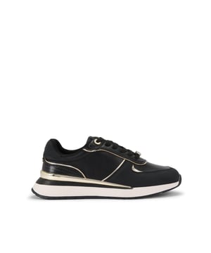 The List is a white sneaker with black and metallic gold panels across the upper. The front laces up with gold tone hardware details.