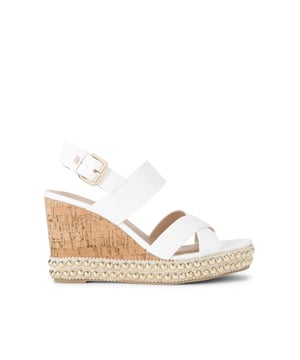 The KG Kurt Geiger Pearl is a wedge heel. There are bone straps across the foot. The wedge heel is in a cork style with statement gold studs around the base. Heel height: 9cm.