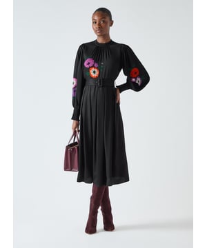 The Fleur dress is ideal for smart-casual events. In classic black with a floral print, this viscose A-line dress boasts a polo neck, full length sleeves with smocked cuffs, and a waist belt. Pair with heels for an exquisite look or ankle boots for laid-back charm. Perfect for brunch, gallery visits, or the office when you want to feel put-together.