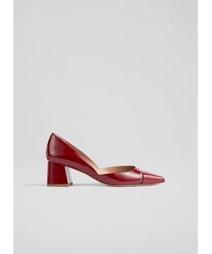 Cecile closed courts blend sophistication with modern flair. Crafted in striking red patent leather, these Spanish crafted courts feature a sleek cut-out design and a pointed toe atop a stylish block heel. Versatile for any occasion, pair them with tailored trousers for a chic office look or a flowing midi dress for an evening out. Enhance your everyday style effortlessly.