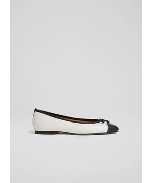 A simple and stylish pair of flats, our Kara ballet pumps are an LKB favourite. Crafted in Spain from beautiful white nappa leather, this timeless style has a round toe with a black leather toe cap and bow detail, and a sleek silhouette. Wear them with tailored trousers or denim when you need a break from heels.