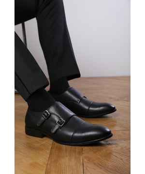 Enhance your formal footwear collection with these Nick Men's Formal Keith Buckle Twin Monk Shoes. Designed with sophistication and comfort in mind, these shoes are the perfect choice for formal occasions, business meetings, or evening events. 
Key Features: 
  Durable Construction: Made with high-quality PU material, these shoes are built to last. The sturdy outsole ensures reliable wear, while the precise stitching adds durability and refinement to the overall design. 
  Chic Design: The double buckle detail offers a distinctive and stylish look, setting these shoes apart from conventional formal footwear. The smooth black finish and clean lines create a polished and sophisticated appearance. 
   Comfortable Fit: Designed for all-day wear, these shoes feature a padded insole that provides excellent cushioning. The slip-resistant outsole ensures stability and comfort, making them ideal for long hours of wear. 
Specifications 
Material: Premium-quality black PU leather 
Closure: Double buckle monk strap. 
Outsole: Durable and slip-resistant 
Elevate your formal attire with these Dominic Men's Formal Keith Buckle Twin Monk Shoes. Combining style, durability, and comfort, they are an essential addition to any wardrobe. Perfect for professionals and fashion-forward individuals alike!