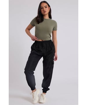 Model is 5'6 and wears a size S.Pockets. Drawstring waist band. Cuff hem. Introducing our Parachute Cargo Trouser, a versatile and stylish addition to your wardrobe that effortlessly combines functionality with fashion-forward design. Crafted with attention to detail and quality, this cargo is perfect for those who seek comfort without compromising on style.