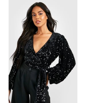Dazzling all-over sequin embellishment
        Luxurious velvet fabric for a festive touch
        Dramatic volume sleeves for added glamour
        Flattering wrap neckline
        Bodysuit design for a seamless silhouette
    
    Make a statement this festive season with our show-stopping Volume Sleeve Velvet Sequin Bodysuit. This eye-catching piece combines the opulence of velvet with the sparkle of sequins, creating a look that's sure to turn heads at any Christmas celebration. The wrap neckline adds a touch of sophistication, while the voluminous sleeves bring drama and flair to your ensemble. Perfect for those who love to shine, this bodysuit can be styled with wide-leg trousers and strappy heels for a chic Christmas party look. Alternatively, pair it with a sleek midi skirt and statement earrings for a glamorous Christmas Day outfit. The bodysuit design ensures a smooth, tucked-in appearance, allowing you to dance the night away without a care. Whether you're attending a festive gathering or hosting your own soire, this dazzling piece will help you celebrate in style.