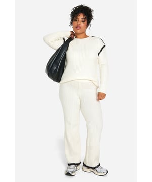 Cosy ribbed knit co-ord set for ultimate comfort
        Contrast trim detail adds a stylish edge
        Relaxed fit pullover with crew neckline
        Wide-leg trousers for a trendy silhouette
        Versatile two-piece ensemble for mix-and-match styling
    
    Embrace laid-back chic with this Plus Premium Pullover and Trouser set from Boohoo. The ribbed knit texture offers a tactile appeal while ensuring warmth and comfort for those casual days out. The contrast trim detail elevates the look, adding a contemporary twist to this cosy ensemble. Perfect for lounging at home or running errands, this co-ord set can be easily dressed up or down. Pair the pullover with your favourite jeans for a quick coffee run, or team the wide-leg trousers with a crisp white tee and trainers for a relaxed weekend look. For a complete outfit, throw on some statement earrings and a crossbody bag. This versatile set is a must-have for the fashion-forward woman who values both style and comfort in her everyday wardrobe.