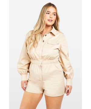 Long-sleeved utility playsuit with collar
        Elasticated waist for a flattering silhouette
        Functional chest pockets for added style and practicality
        Button-up front closure for easy wear
        Relaxed fit shorts for comfort and movement
    
    This versatile utility playsuit is the perfect addition to your going-out wardrobe. The long sleeves and collared neckline add a touch of sophistication, while the elasticated waist creates a flattering shape. Style it with trainers and oversized sunglasses for a cool daytime look, or dress it up with heeled sandals and statement jewellery for a night out with friends. The relaxed fit shorts ensure comfort for dancing the night away, while the functional chest pockets add a practical edge to this trendy piece. Whether you're heading to a bar for drinks or meeting new people at a club, this playsuit will have you looking effortlessly chic and ready for any urban adventure.