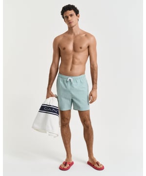  
 Crafted from 100% recycled polyester, these GANT swim shorts are essential for the summer season. Detailed with an all-over seersucker pattern and cut for a regular fit, they have a mid-thigh length and a regular waist. They feature an embroidered GANT shield on the left leg, side seam pockets, a single back pocket, and an elasticated drawstring waistband. This product is made with recycled polyester.

Regular fit
Mid-thigh length
Regular waist
GANT graphic embroidered on left leg

 85% Recycled Polyester, 15% Cotton 

922516001
 