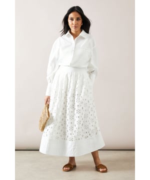 Exquisite broderie anglaise pattern throughout
        Flattering midi length for versatile styling
        High-waisted design for a feminine silhouette
        Fully lined for comfort and coverage
        Wide hem band adds structure and visual interest
    
    This charming broderie midi skirt from Wallis is a must-have for your warm-weather wardrobe. The intricate eyelet detailing lends a touch of romance and sophistication to any ensemble. Perfect for casual daytime events, this skirt pairs beautifully with a crisp white blouse and flat sandals for a relaxed yet polished look. The high-waisted cut and midi length create a flattering shape that suits a variety of body types. For family gatherings or weekend brunches, style it with a lightweight knit top and espadrilles. The versatile design allows for easy transition from day to evening - simply swap your flats for low heels and add some delicate jewellery for a more dressed-up appearance. With its timeless appeal and comfortable cotton fabric, this skirt is sure to become a favourite in your collection.