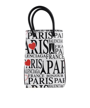 Bolso Balenciaga Shopping North South XS.Piel blanca.Estampados turísticos  Bonjour Paris  en rojo y negro.Dos asas negras.Logotipo en el interior.Cierre a presión plateado.Dimensiones: alto: 18 cm x ancho: 13 cm x fondo: 5 cm. Made in Italy.