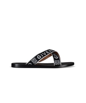 Sandalias de cuero negro Givenchy.Logotipo en la suela y las correas.Tacones bajos y planos con tiras de tela.Made in Italy.