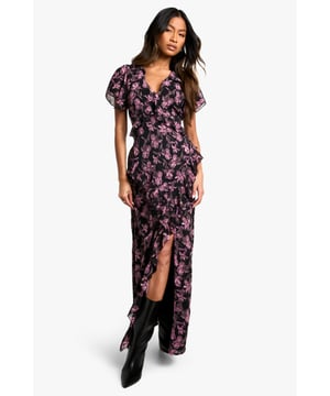 Alluring V-neckline for a feminine touch
        Flowy maxi length with a daring side slit
        Captivating floral print throughout
        Flattering wrap-style silhouette
        Short flutter sleeves for a romantic flair
    
    Make a lasting impression in this enchanting floral maxi dress, perfect for your next night out. The wrap-style silhouette gracefully hugs your curves, while the daring side slit adds a touch of allure to your ensemble. The V-neckline and short flutter sleeves create a romantic and feminine look that's sure to turn heads. Style this versatile piece with strappy heels and a clutch for a sophisticated cocktail party, or dress it down with ankle boots and a leather jacket for a chic dinner date. The maxi length offers elegance and drama, making it an ideal choice for various evening events. Whether you're dancing the night away or enjoying drinks with friends, this dress will keep you looking effortlessly stylish and ready for any urban adventure.
