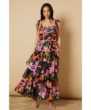 Feminine ruched bodice with elegant gathering that creates a flattering silhouette
        Charming tie straps with ruffle detail for an adjustable fit and pretty finish
        Tiered midi skirt design with beautiful movement and volume
        Striking floral print that captures Oasis's signature feminine aesthetic
        Square neckline that frames the dcolletage beautifully
    
    This enchanting midi dress from Oasis embodies romantic charm with its thoughtfully designed ruched bodice and playful tiered skirt. The delicate tie straps can be adjusted to your perfect fit, while the ruffle detailing adds a touch of whimsy to this occasion-ready piece. Style with strappy heeled sandals as seen on our model for garden parties and summer weddings, or dress it up with statement earrings and an elegant clutch for formal events. The flowing tiered design creates beautiful movement as you walk, making it ideal for those special moments that call for something truly memorable. For cooler evenings, layer with a lightweight pashmina or tailored blazer to maintain that refined silhouette whilst staying comfortable throughout your event.