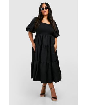 Tiered and ruched design for a flattering silhouette
        Square neckline adds a touch of elegance
        Voluminous puff sleeves create a dramatic look
        Midi length offers versatile styling options
        Smocked bodice ensures a comfortable fit
    
    Make a statement in this eye-catching tiered and ruched smock dress from Boohoo. Perfect for the fashion-forward woman who loves to embrace current trends, this dress combines comfort with style. The square neckline and puff sleeves add a touch of romance, while the tiered skirt creates movement and dimension. Ideal for casual events or family gatherings, this dress can be easily dressed up or down. Pair it with strappy sandals and statement earrings for a daytime look, or switch to heeled mules and a clutch bag for evening drinks. The midi length offers coverage whilst still allowing you to show off your favourite footwear. Whether you're heading to a garden party or a casual dinner date, this versatile dress will ensure you're always on-trend and feeling confident.