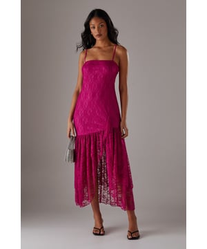 Delicate all-over lace fabric creates a romantic, feminine aesthetic
        Flattering drop waist silhouette with dramatic ruffle detail
        Elegant strappy neckline adds a contemporary touch
        Semi-sheer lace ruffle creates an asymmetric midi hemline
        Lined bodice ensures comfort and coverage where needed
    
    This striking Warehouse midi dress combines sophisticated design with bold femininity. The form-fitting bodice transitions into a playful drop waist ruffle, creating a silhouette that's both flattering and fashion-forward. The delicate lace fabric offers a beautiful textural contrast whilst the asymmetric hemline adds movement and drama. Style with strappy heels and a metallic clutch as shown for evening events, or dress down with leather mules and a tailored blazer for summer garden parties. Perfect for weddings, races or formal occasions where you want to make an impression, this versatile piece can be accessorised with statement jewellery for additional glamour or kept minimal to let the intricate lace detailing take centre stage. The strappy neckline frames the dcolletage beautifully, making this a confident choice for those special moments when you wish to command attention.