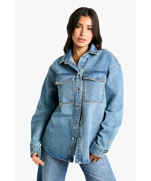 Oversized fit for a relaxed, on-trend silhouette
        Studded detailing adds an edgy, rock-inspired touch
        Chest pockets with stud-trimmed flaps for added style and functionality
        Long sleeves with buttoned cuffs for versatile wear
        Classic collar and button-down front for a timeless denim look
    
    Make a bold statement with this Tall Oversize Jeanshemd, perfect for the fashion-forward woman who loves to stand out. The oversized fit offers a contemporary twist on the classic denim shirt, while the eye-catching studded details add a touch of rock-chic glamour. Style this versatile piece for a range of casual occasions - pair it with wide-leg jeans and trainers for a cool, double-denim look, or throw it over a simple dress for an effortlessly stylish ensemble. For a more laid-back vibe, leave it unbuttoned over a crop top and high-waisted trousers. The shirt's adaptable nature makes it ideal for family gatherings, brunches with friends, or casual nights out. Its durable denim fabric ensures comfort and longevity, making it a wardrobe staple that you'll reach for time and time again. Embrace the oversized trend and let this studded denim shirt become your go-to piece for effortless, eye-catching style.