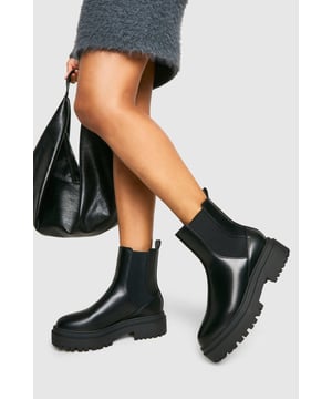Chunky platform sole for added height and style
        Classic Chelsea boot design with elastic side panels
        Mid-heel height between 5 and 6.5cm for comfortable wear
        Sleek, smooth upper for a polished look
        Durable tread pattern on the sole for improved grip
    
    Step out in confidence with these eye-catching Chelsea boots from Boohoo. The chunky platform sole adds a contemporary twist to the timeless Chelsea boot silhouette, perfect for the fashion-forward woman who loves to make a statement. Pair these versatile boots with a fluffy mini skirt and an oversized jumper for a chic autumn ensemble, or style them with straight-leg jeans and a leather jacket for an edgy night-out look. The mid-heel height offers the ideal balance of style and comfort, making these boots suitable for various casual occasions, from family gatherings to weekend brunches with friends. Their durable construction and practical design ensure they'll become a go-to choice in your wardrobe, seamlessly transitioning from day to night with ease.