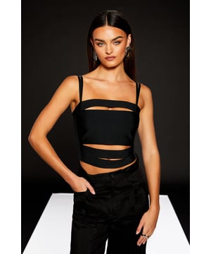Striking bandeau neckline with daring cutout details
        Sleek jersey fabric for a comfortable, body-hugging fit
        Versatile bralet design perfect for layering or wearing solo
        Part of the edgy RUNWAY 1.8.1.8 collection
        Cropped length ideal for high-waisted bottoms
    
    Make a bold statement with this Runway 1.8.1.8 Strap Cutout Bralet from Warehouse. This daring piece showcases a unique bandeau design with eye-catching cutout details, perfect for the fashion-forward woman who loves to stand out. The sleek jersey fabric ensures a comfortable, figure-flattering fit that moves with you throughout the day. Style this versatile top with high-waisted wide-leg trousers and strappy heels for a chic daytime look that transitions seamlessly into evening drinks. For a more casual ensemble, pair it with your favourite high-rise jeans and trainers. This bralet is an excellent choice for various daytime events, from brunches with friends to art gallery visits. Its edgy design allows for creative layering options, making it a dynamic addition to your wardrobe that can be dressed up or down to suit any casual occasion.