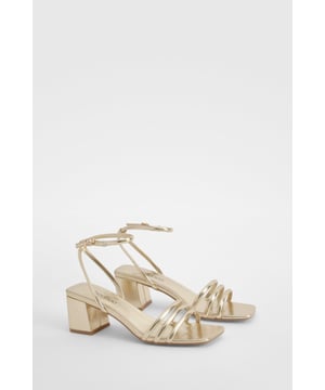 Chic square-toe design for a modern aesthetic
        Multiple slim straps across the foot for a delicate look
        Ankle strap with adjustable buckle fastening
        Comfortable low block heel (between 2.5 and 4.5cm)
        Versatile style suitable for various occasions
    
    Step out in style with these elegant square-toe sandals, perfect for adding a touch of sophistication to your evening ensemble. The multiple slim straps create a delicate and feminine look, while the adjustable ankle strap ensures a secure fit. The low block heel offers comfort without compromising on style, making these sandals ideal for dancing the night away or enjoying drinks with friends. Pair them with a sleek midi dress for a chic night out, or dress them down with cropped trousers for a more casual yet refined look. These versatile sandals are a must-have addition to your wardrobe, seamlessly transitioning from day to night and complementing a wide range of outfits for various social occasions.