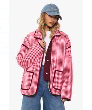 Oversized jacket featuring eye-catching gingham print with contrasting trim detailing
        Roomy front pockets with decorative piping for both style and functionality
        Relaxed drop-shoulder design offering a contemporary silhouette
        Button-through front closure for easy wear and versatility
        High collar that can be worn up or down depending on your style preference
    
    Make a bold statement with this striking oversized jacket that combines retro charm with modern styling. The distinctive gingham pattern creates visual interest while the generous cut ensures comfort for everyday wear. Style it as seen with wide-leg jeans and a simple white tee for an effortlessly cool daytime look, or layer over a fitted dress for a playful contrast in proportions. Perfect for casual outings, weekend brunches or family gatherings, this jacket works brilliantly with trainers for a relaxed vibe. For cooler days, add a beanie and chunky scarf to complete the look. The versatile design transitions seamlessly from autumn strolls to spring picnics, making it a wardrobe staple that will refresh your casual collection with its distinctive character and relaxed appeal.