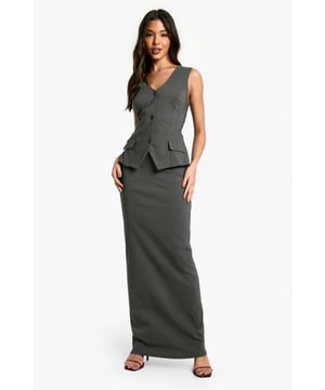 Sleek maxi dress with a plunging neckline for a daring look
        Structured waistcoat-style top with functional buttons
        Figure-hugging bengaline fabric for a smooth silhouette
        Practical side pockets add a functional touch
        Floor-length skirt with a subtle flare for ease of movement
    
    Make a statement on your next night out with this striking waistcoat maxi dress. The plunging neckline and structured top create a bold, confident look, while the figure-hugging bengaline fabric ensures a flattering fit. Perfect for those who want to turn heads at the club or bar, this dress combines sophistication with urban edge. Style it with strappy heels and a clutch bag for a polished ensemble, or dress it down with chunky trainers and a leather jacket for a more casual vibe. The versatile design allows for easy transition from drinks with friends to dancing the night away. Add some statement jewellery to really make this look your own and showcase your personal style.